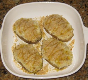 Stuff the potato shells, sprinkle with cracker crumbs and drizzle with olive oil