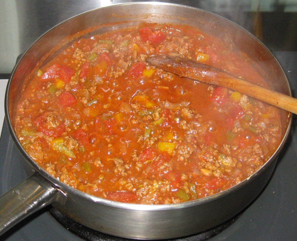 Brown the meat, add the tomatoes, herbs and spices, and simmer.