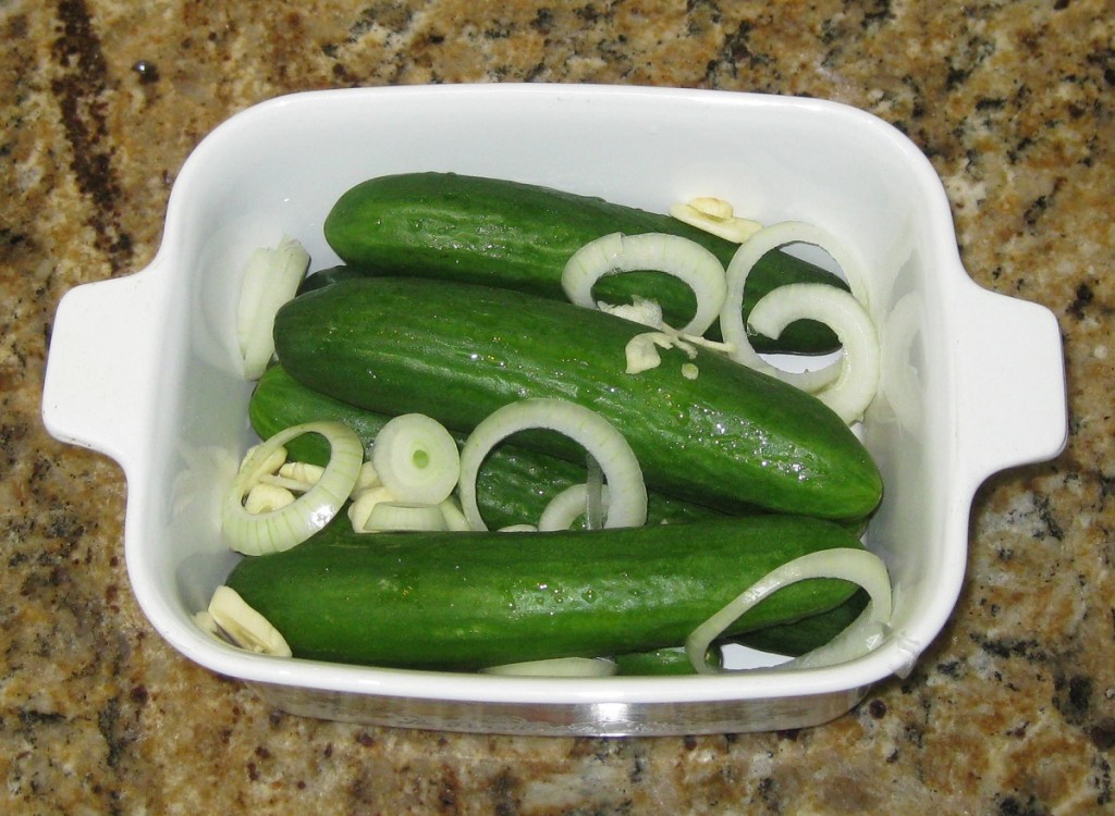 Arrange the cucumbers, garlic and onion in a container